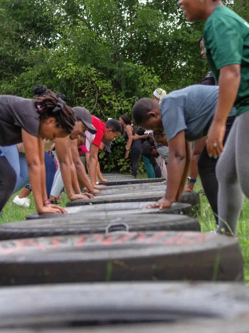Women moving together at an outdoor Mamahood event